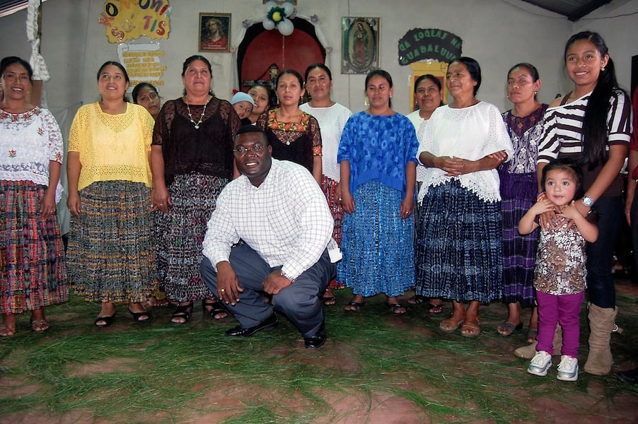 missionary-priest-smiles-with-parishioners-in-Guatemala