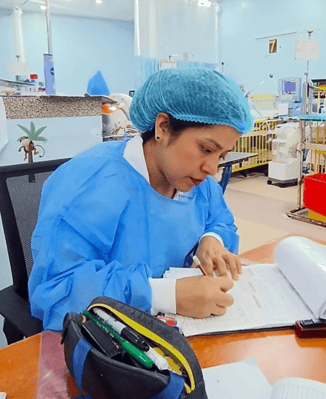 Milgros takes notes in a regional hospital where she works as a nurse.